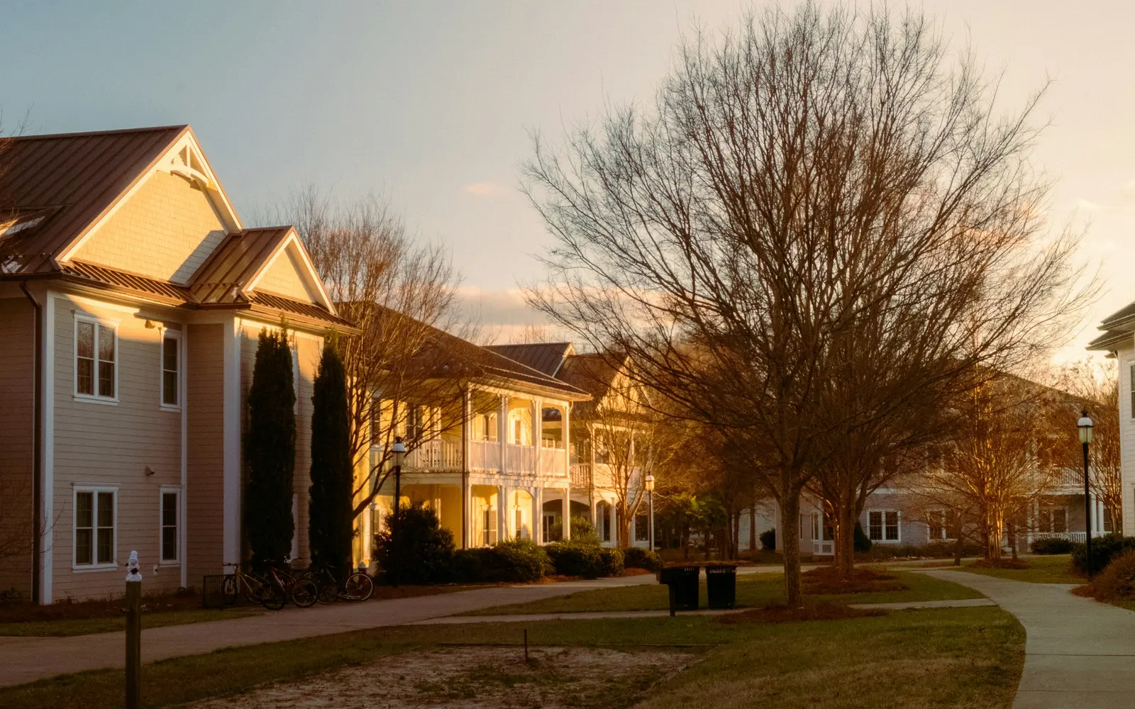 A senior living community at golden hour with walking paths between residences